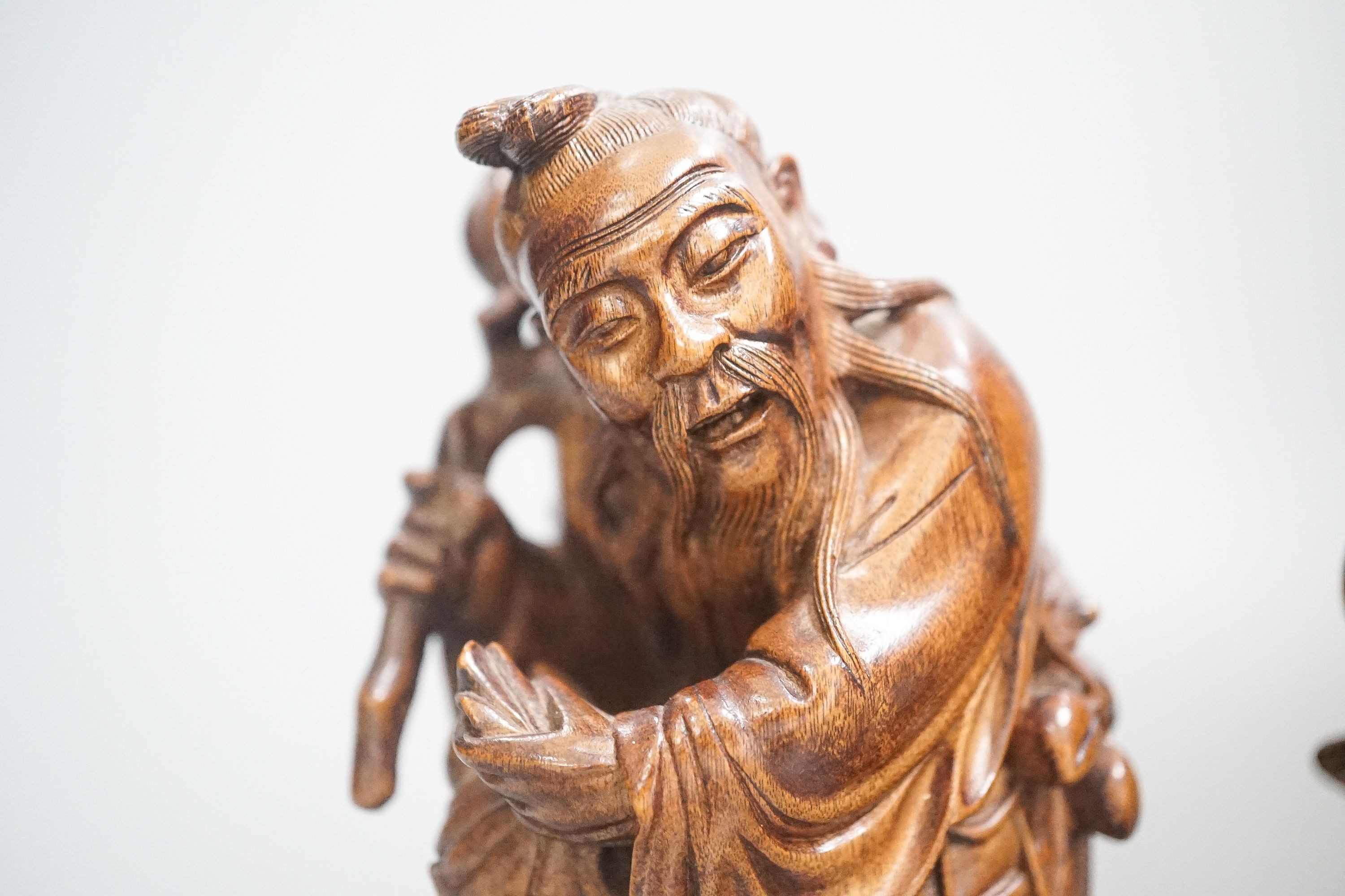 Two Chinese hardwood figures of a fisherman and a old man holding peaches 16cm